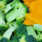 A close up of broccoli and carrots on a plate
