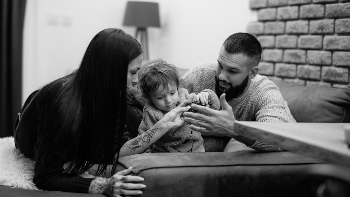 a man, woman and child sitting on a couch